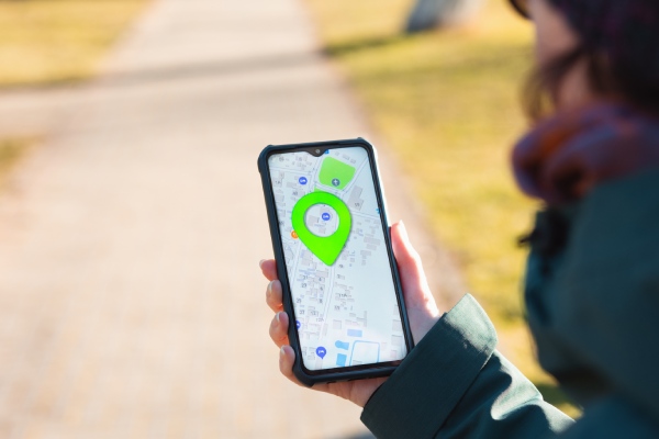 A woman holds a cellphone with the online maps app